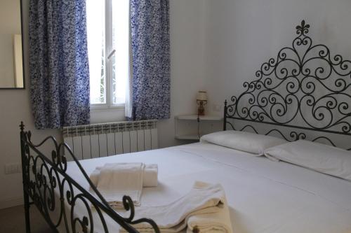 a bedroom with a large white bed with blue curtains at Appartamento Redentore in Venice