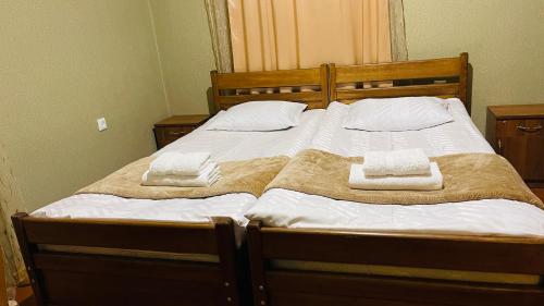 a bedroom with a bed with two towels on it at Guesthouse Chela in Mestia