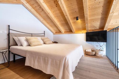 a bedroom with a large bed and wooden ceilings at Luxury Seaview Apartment - Mare in Slano