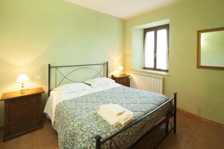 a bedroom with a large bed and a window at Il poggio dei tre contadini in Ponte Felcino
