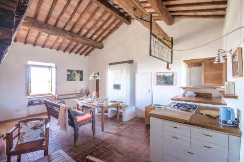 a kitchen with a table and a dining room at Country House Art and Garden in Monte Antico