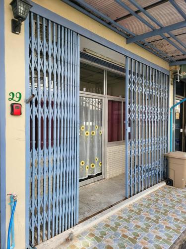 an entrance to a building with a metal gate at Achcha hotel - itsaraphap MRT station - Wat Arun in Bangkok