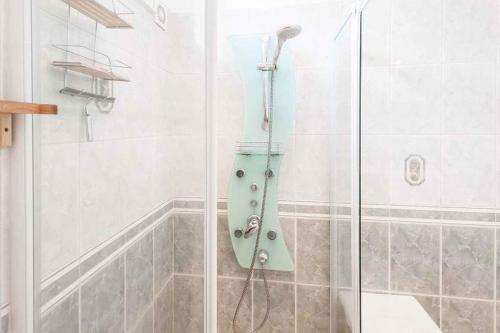 a shower with a glass door in a bathroom at Holiday home in Budapest 34304 in Budapest