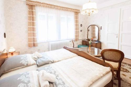 a bedroom with a bed and a table and a mirror at Holiday home in Budapest 34304 in Budapest