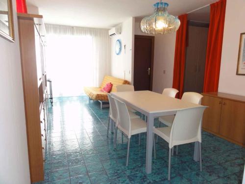 a dining room with a white table and chairs at Apartments in Bibione 36469 in Bibione