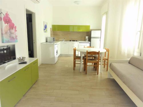 a kitchen and living room with a table and chairs at Holiday home in Bibione 41088 in Lo Stallone