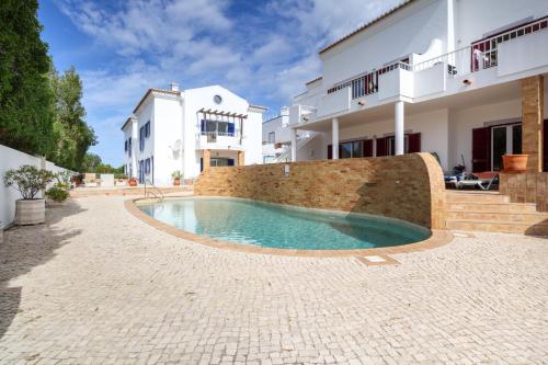 a swimming pool in front of a house at Casa Luna, Burgau - Luz, Lagos in Burgau