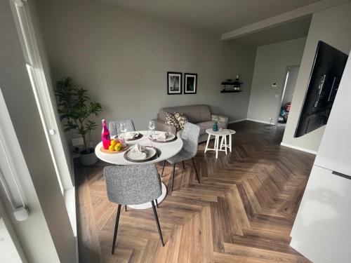 a living room with a table and chairs and a dining room at Iceland SJF Apartments - 503 in Reykjavík