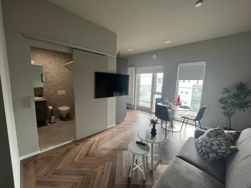 a living room with a couch and a table at Iceland SJF Apartments - 503 in Reykjavík