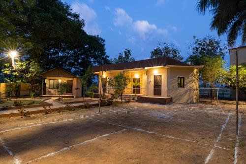 a house with a parking lot in front of it at Avadale Tadoba - Stag Groups Not Allowed in Mohurli