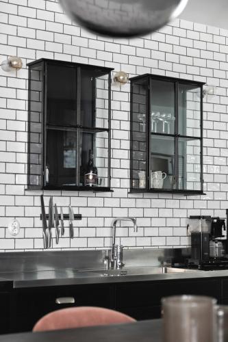 a kitchen with a sink and two glass cabinets at Villa S:t Hans in Visby