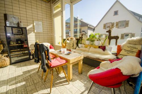 a room with a table and chairs in a store at Badischer Landgasthof Hirsch in Hügelsheim