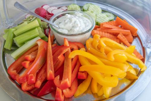 a plate of vegetables with dip on a table at Hotel Viva Sky in Konstanz