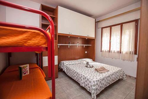 a bedroom with two beds and a bunk bed at Apartment in Rosolina Mare 43995 in Rosolina Mare