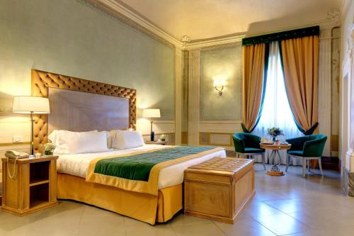 
a hotel room with two beds and two lamps at Villa Tolomei Hotel & Resort in Florence
