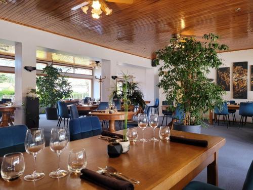 Hotel Les Glycines في Vieille-Brioude: طاولة في مطعم مع كؤوس النبيذ عليه
