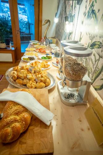 a table topped with plates of food and bread at NATURION Hotel Hinterzarten in Hinterzarten