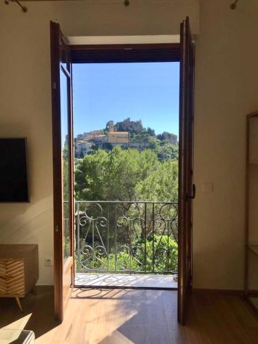 an open door to a balcony with a view at Villa d exception avec terrasse, jacuzzi, vue mer, parking, en plein cœur du village de Eze in Éze