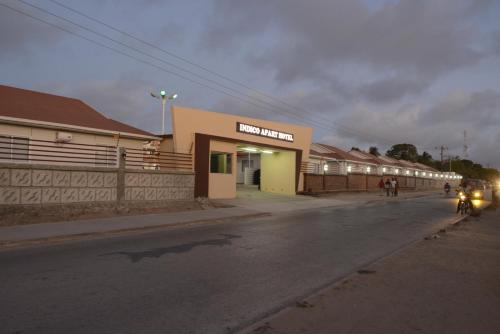 a building on the side of a street at night at Indico Apart Hotel in Cidade de Nacala
