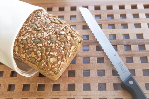 a piece of bread on a table next to a knife at Hotel Viva Sky in Konstanz