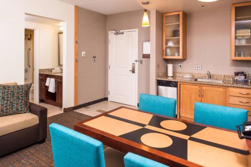 a living room with a table and a kitchen at Residence Inn Pittsburgh North Shore in Pittsburgh