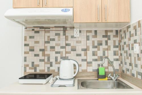 a kitchen counter with a sink and a mixer at Kristina Stelios Apartment in Plataniás