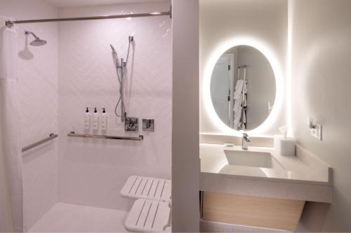 a white bathroom with a sink and a mirror at TownePlace Suites by Marriott Ellensburg in Ellensburg