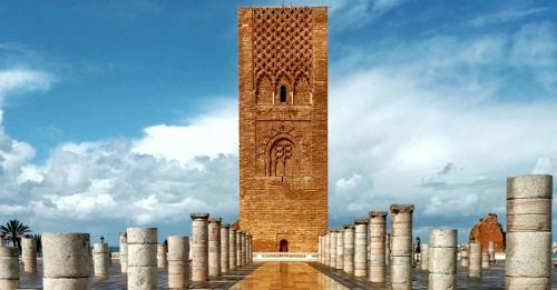 a tall brick tower with a bunch of columns around it at Luxueux Appartement DOWNTOWN RABAT in Rabat