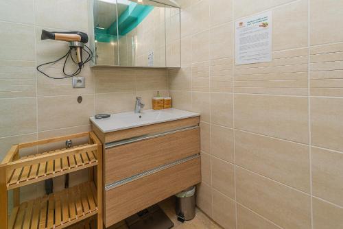 a bathroom with a sink and a mirror at Au Château de Villelongue B&B in Villelongue-dʼAude