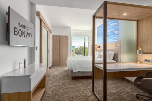 a hotel room with a bed and a desk at SpringHill Suites by Marriott Bradenton Downtown/Riverfront in Bradenton