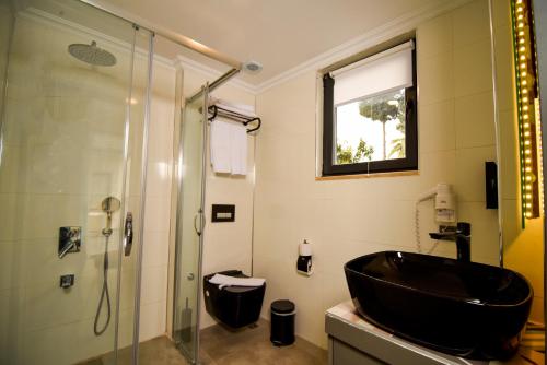 a bathroom with a black sink and a shower at Remarkable Flat with Balcony near Hadrian's Gate in Antalya