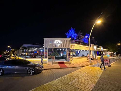 a car parked in front of a store at night at Agartha Suite Hotel Kemer in Kemer
