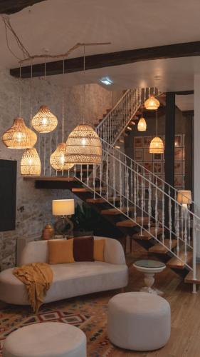 a living room with a couch and a staircase at Quinta de Travassinhos- Douro Valley & Spa in Santa Marta de Penaguião
