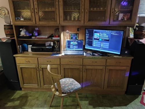a desk with a computer and a laptop on it at Alpenblick Bed & Breakfast in Vipiteno