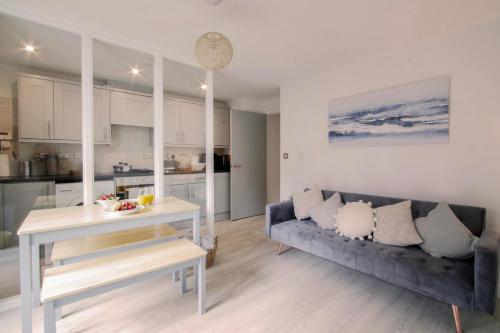 a living room with a couch and a table at Apartments in the heart of Penzance in Penzance