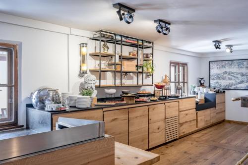 a large kitchen with wooden cabinets and a counter at Mondschein Hotel & Chalet in Stuben am Arlberg
