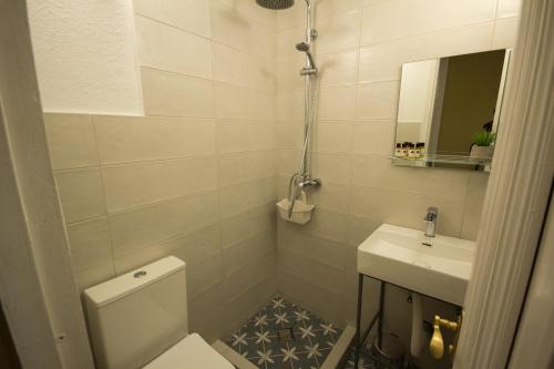 a small bathroom with a toilet and a sink at Hotel Kartli in Tbilisi City