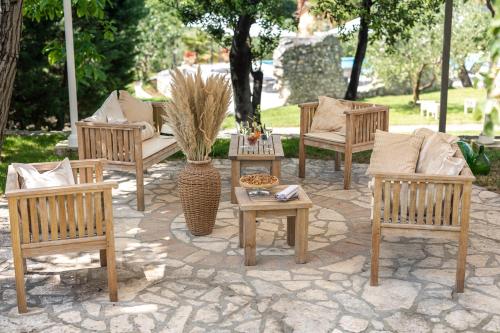 a group of chairs and tables on a patio at Boutique Hotel San Rocco in Brtonigla