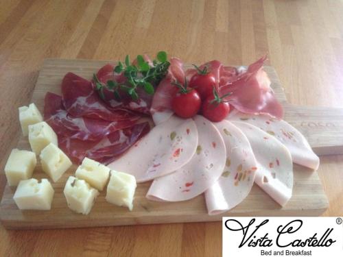 a plate of meat and cheese on a cutting board at Vista Castello in Rovereto