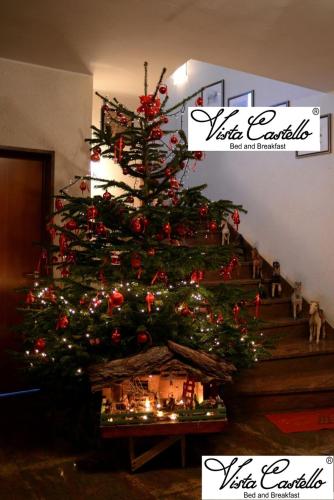 a christmas tree on the side of a staircase at Vista Castello in Rovereto