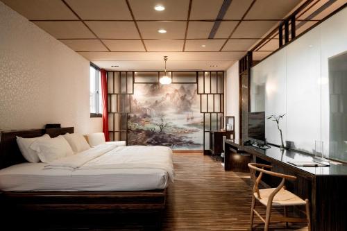 Una cama o camas en una habitación de Tian Xia Ju