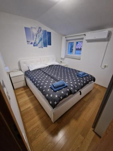a bedroom with a bed with blue pillows on it at Beautiful house Lanna in Izola