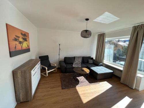 a living room with a couch and a tv at Ferienhaus Butterfly 2 in Garmisch-Partenkirchen