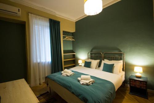 a bedroom with a bed with towels on it at Hotel Kartli in Tbilisi City
