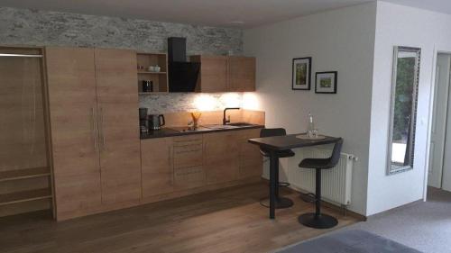 a kitchen with a counter and a table in a room at Spreewaldhof Romantik - Hotel Garni in Neu Zauche