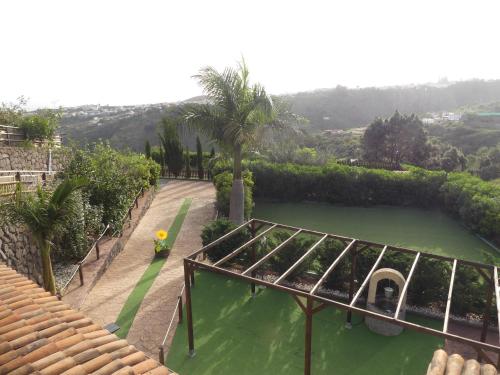 a view of a garden with a pool of water at Holiday Home El Brezal in El Palmital