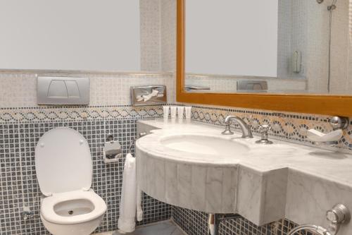 a bathroom with a sink and a toilet and a mirror at Sharm Dreams Vacation Club - Aqua Park in Sharm El Sheikh