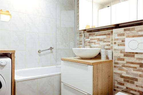 a bathroom with a sink and a bowl on a counter at Elegant 1-bedroom apartment near hill forest in Ljubljana