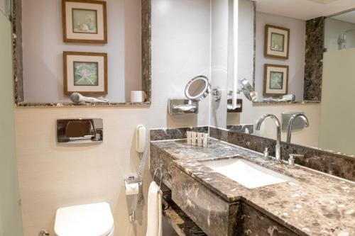 a bathroom with a sink and a toilet at Sharm Dreams Vacation Club - Aqua Park in Sharm El Sheikh