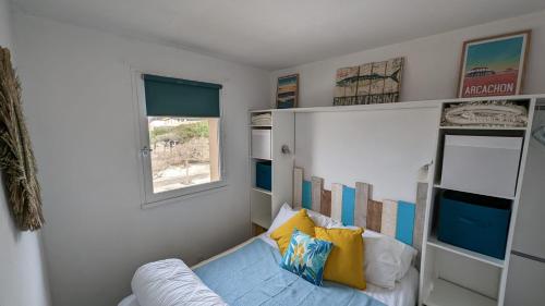 a living room with a couch and a window at appartement T2 biscarosse plage in Biscarrosse-Plage